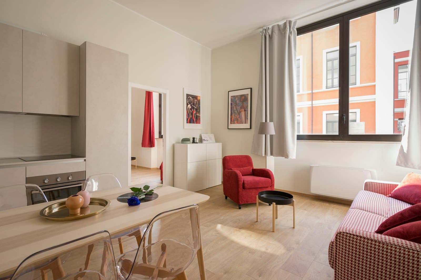 Furnished living and dining area with a window onto the street